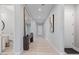 Bright hallway with a large mirror, neutral tile flooring, and entry to bathroom at 4330 S Neutron --, Mesa, AZ 85212
