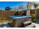 Modern hot tub, situated on a paved patio surrounded by desert plants with privacy fence at 4330 S Neutron --, Mesa, AZ 85212