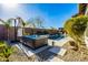 Backyard hot tub surrounded by desert landscaping with partial views of the swimming pool at 4330 S Neutron --, Mesa, AZ 85212