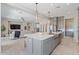 Open-concept kitchen island with pendant lighting, seating, and view to the living area at 4330 S Neutron --, Mesa, AZ 85212