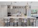 Well-lit kitchen island featuring pendant lighting, gray cabinets, and modern seating at 4330 S Neutron --, Mesa, AZ 85212