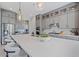 Modern kitchen featuring grey cabinets, stainless steel appliances, a large island and stylish pendant lighting at 4330 S Neutron --, Mesa, AZ 85212