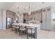 Spacious kitchen island with modern stools, gray cabinets, and pendant lighting at 4330 S Neutron --, Mesa, AZ 85212