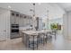 Elegant kitchen featuring a large island, gray cabinets, and modern bar stools at 4330 S Neutron --, Mesa, AZ 85212
