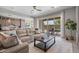 Open-concept living room showcasing stylish furniture, a sliding glass door to the backyard and modern decor at 4330 S Neutron --, Mesa, AZ 85212