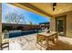 Outdoor patio with dining set, view of the pool, pergola and lush landscaping at 4330 S Neutron --, Mesa, AZ 85212