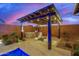 Outdoor living area with pergola, outdoor kitchen, grill, and comfortable seating around the pool at 4330 S Neutron --, Mesa, AZ 85212