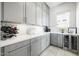 Pantry featuring gray cabinets with plenty of storage, white backsplash, counter space and beverage cooler at 4330 S Neutron --, Mesa, AZ 85212