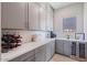 Well-organized pantry with gray cabinets, ample countertop space, wine rack, and beverage cooler at 4330 S Neutron --, Mesa, AZ 85212