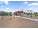 Inviting community playground with a hammock swing and climbing net, perfect for outdoor play at 4330 S Neutron --, Mesa, AZ 85212
