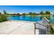 Park bench overlooking a pond, surrounded by serene water and green trees, perfect spot for community relaxation at 4330 S Neutron --, Mesa, AZ 85212