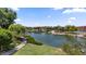 A peaceful pond with an island gazebo offering a serene escape within a residential community, with lush landscaping at 4330 S Neutron --, Mesa, AZ 85212