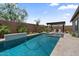 Backyard pool area with well-kept landscaping and a pergola with seating and an outdoor kitchen at 4330 S Neutron --, Mesa, AZ 85212