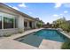 Beautiful backyard pool with a baja shelf, complemented by patio and mature landscaping at 4330 S Neutron --, Mesa, AZ 85212