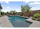 Relaxing backyard pool featuring a spa, mature landscaping, and a brick privacy wall at 4330 S Neutron --, Mesa, AZ 85212