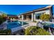 A view of a sparkling swimming pool with spa, patio seating and mature landscaping at 4330 S Neutron --, Mesa, AZ 85212