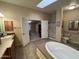 Open bathroom design featuring a soaking tub, a shower stall, and a seamless entry into the bedroom at 437 E Germann Rd # 152, San Tan Valley, AZ 85140