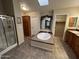 This bathroom features a soaking tub, a shower stall, and dual sinks with decorative accents at 437 E Germann Rd # 152, San Tan Valley, AZ 85140