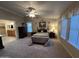 This bedroom has neutral tones, a ceiling fan, and bright windows, adjacent to the bathroom at 437 E Germann Rd # 152, San Tan Valley, AZ 85140