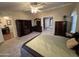 Comfortable main bedroom boasting carpet floors, natural light, a ceiling fan, and ensuite bathroom at 437 E Germann Rd # 152, San Tan Valley, AZ 85140