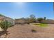 A spacious backyard featuring low-maintenance desert landscaping, a storage shed, and block wall fencing at 43945 W Juniper Ave, Maricopa, AZ 85138