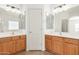 Bright bathroom featuring double sinks, spacious counters, and a well-lit vanity at 43945 W Juniper Ave, Maricopa, AZ 85138