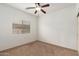 Bedroom featuring a ceiling fan, a window, and neutral carpet at 43945 W Juniper Ave, Maricopa, AZ 85138