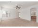 Spacious bedroom with carpeted floors, a ceiling fan, and an ensuite bathroom at 43945 W Juniper Ave, Maricopa, AZ 85138