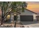 Charming single-story home with a two-car garage, desert landscaping, and a welcoming front entrance at 43945 W Juniper Ave, Maricopa, AZ 85138