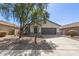 Charming single-story home with a well-maintained front yard and a two-car garage at 43945 W Juniper Ave, Maricopa, AZ 85138