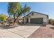 Beautiful single-story home with desert landscaping and a long driveway leading to the garage at 43945 W Juniper Ave, Maricopa, AZ 85138