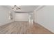 Bright living room featuring wood-look tile flooring and natural light at 43945 W Juniper Ave, Maricopa, AZ 85138