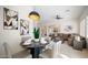 Open-concept dining room with a modern light fixture and a view into the living room at 4831 E Annette Dr, Scottsdale, AZ 85254