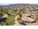 Expansive aerial view of the golf course, showcasing mountain views and beautiful real estate in the distance at 4843 E Ajo Cir, Phoenix, AZ 85044