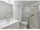 Well-lit bathroom features a shower with safety bars, and a white sink and toilet at 4843 E Ajo Cir, Phoenix, AZ 85044