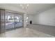 Bright living room with tiled floors, neutral carpeting, and sliding glass doors to covered patio at 4843 E Ajo Cir, Phoenix, AZ 85044