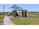 Community picnic area with grill, picnic table, and shady spots surrounded by greenery at 4848 W Hunter Trl, San Tan Valley, AZ 85144