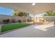 Inviting backyard featuring a covered patio, manicured turf, and sand landscape for easy upkeep at 4932 W Golden Ln, Glendale, AZ 85302