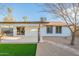 Outdoor space with a covered patio, desert landscaping, and a glimpse of the home's architecture at 4932 W Golden Ln, Glendale, AZ 85302