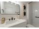 Modern bathroom with quartz countertops, matte black fixtures, and decorative art at 4932 W Golden Ln, Glendale, AZ 85302