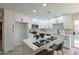 Updated kitchen with white cabinetry, modern appliances, and a functional center island with seating at 4932 W Golden Ln, Glendale, AZ 85302