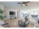 Spacious living room showcasing an open floor plan with a modern ceiling fan and updated decor at 4932 W Golden Ln, Glendale, AZ 85302