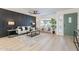 Inviting living room featuring an accent wall, stylish furniture, and a modern green front door at 4932 W Golden Ln, Glendale, AZ 85302