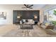 Comfortable living area with an accent wall, stylish furniture, neutral rug, and natural light at 4932 W Golden Ln, Glendale, AZ 85302