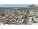 Expansive aerial view of a residential neighborhood with a canal and mountain backdrop at 4950 N Miller Rd # 119, Scottsdale, AZ 85251