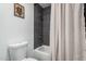 Cozy bathroom featuring a shower over a bathtub with gray tiling and complementary neutral color scheme at 4950 N Miller Rd # 119, Scottsdale, AZ 85251