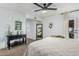 Bright bedroom with a ceiling fan, full-length mirror, and a unique decorative shelving display at 4950 N Miller Rd # 119, Scottsdale, AZ 85251