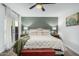 Comfortable bedroom with a sage green accent wall, ceiling fan and natural lighting from a French door at 4950 N Miller Rd # 119, Scottsdale, AZ 85251