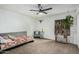 Minimalist bedroom with light walls, ceiling fan, and decorative plants for added visual interest at 4950 N Miller Rd # 119, Scottsdale, AZ 85251