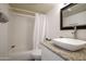 Bathroom featuring granite-look vanity with vessel sink, framed mirror, and shower-tub combo at 5223 N 24Th St # 108, Phoenix, AZ 85016